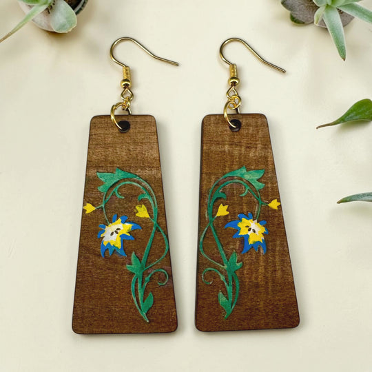 Wooden earrings with floral designs on a light background