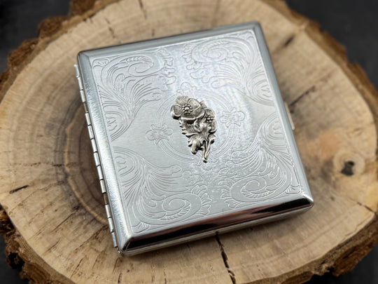 Minimalist silver business card holder with decorative stamped frame and finely textured metal surface
