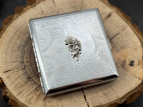 Minimalist silver business card holder with decorative stamped frame and finely textured metal surface