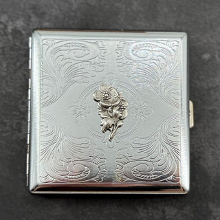 Compact silver cigarette case showcasing an elegant textured stamping with vintage-inspired detailing