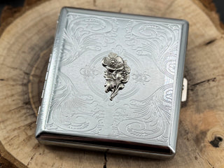 Decorative silver pocket case featuring a finely stamped geometric pattern and ornate border design