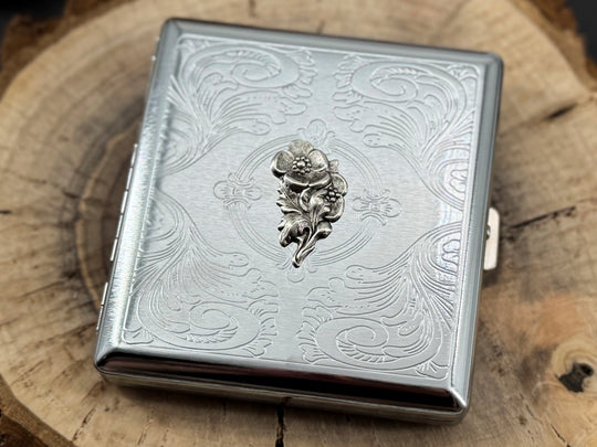 Decorative silver pocket case featuring a finely stamped geometric pattern and ornate border design