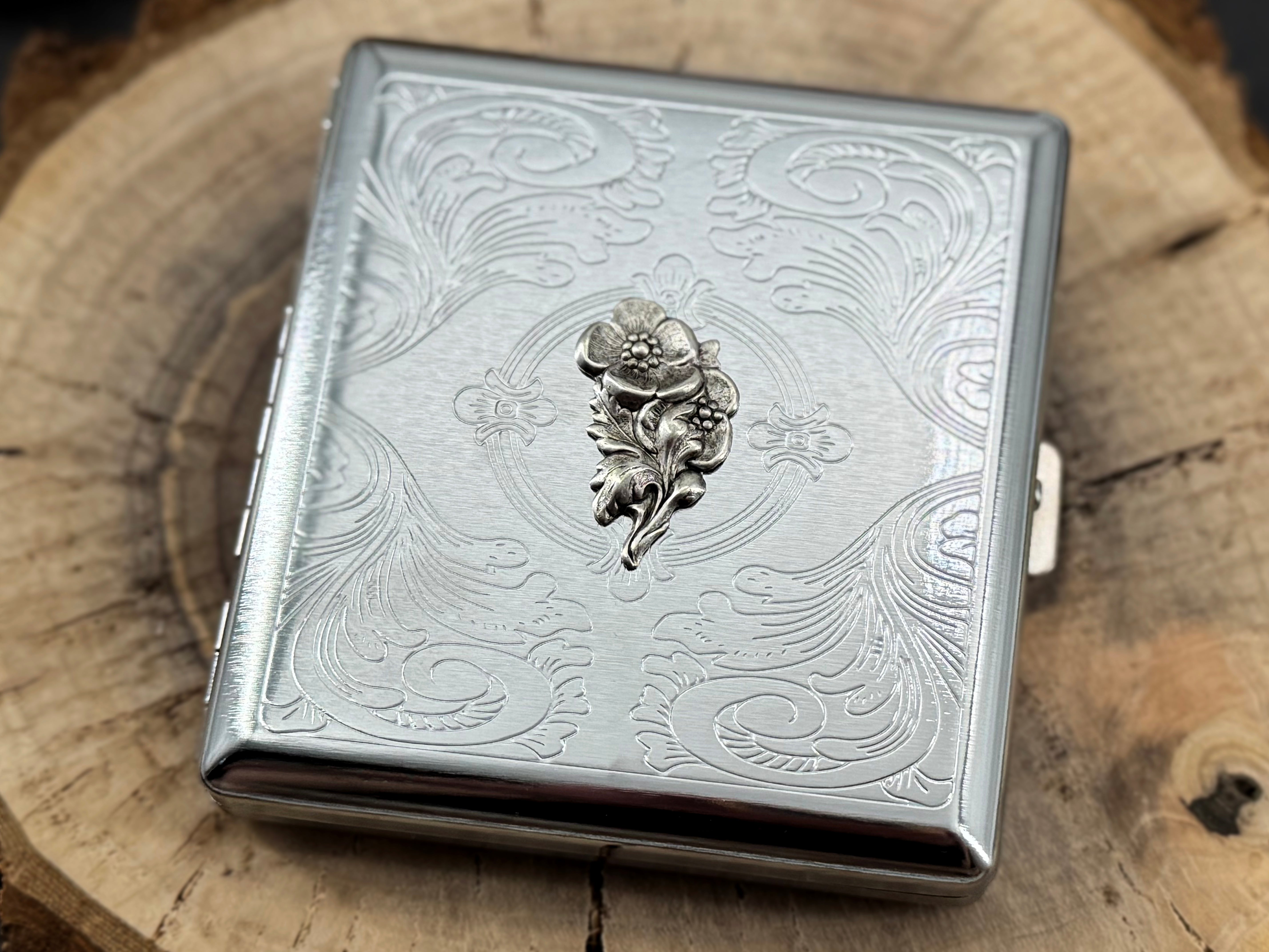 Decorative silver pocket case featuring a finely stamped geometric pattern and ornate border design
