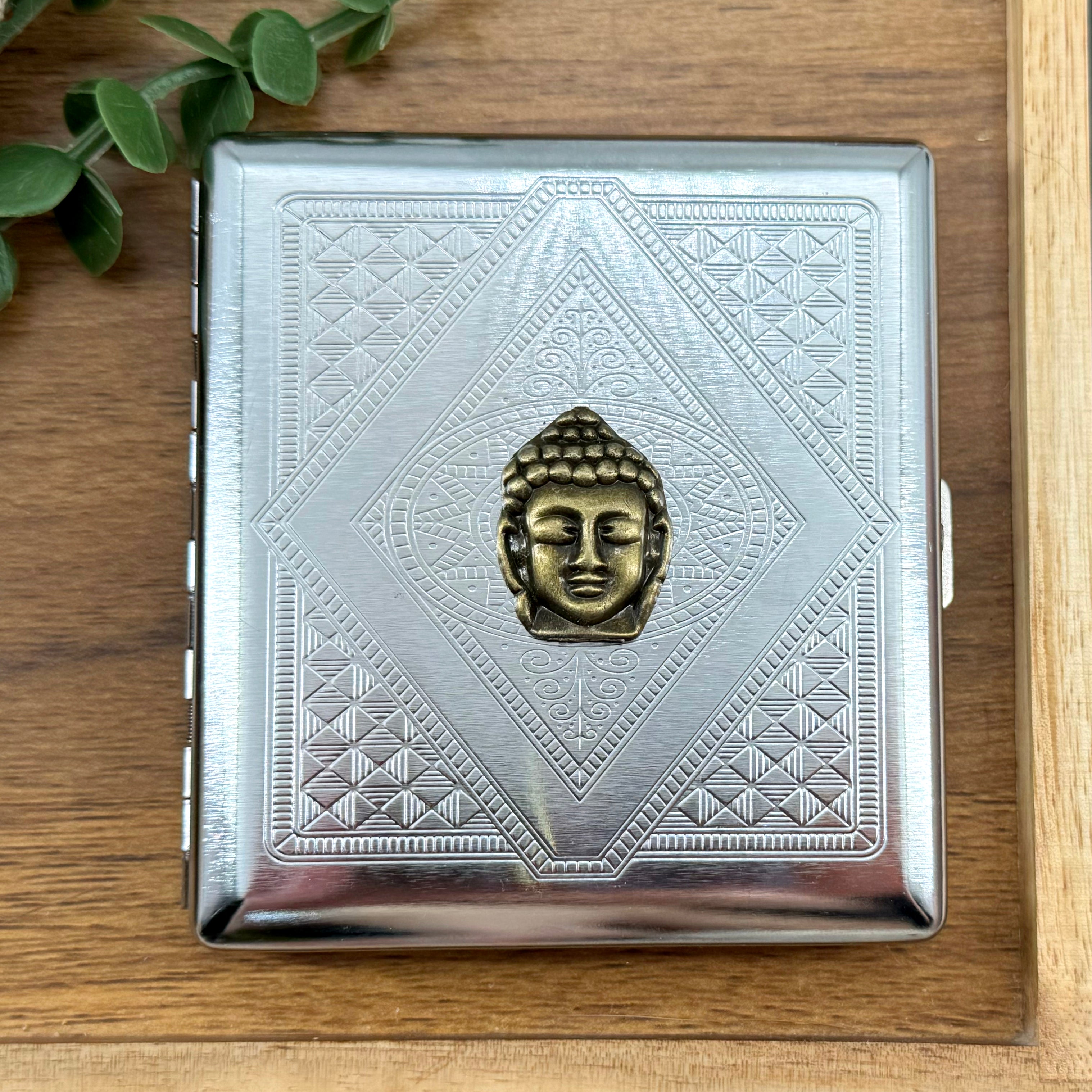 Zen Buddha cigarette case with raised bronze Buddha on silver stamped geometric metal background