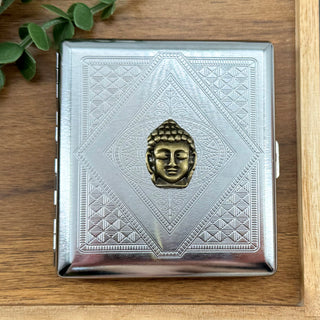 Zen Buddha cigarette case with raised bronze Buddha on silver stamped geometric metal background