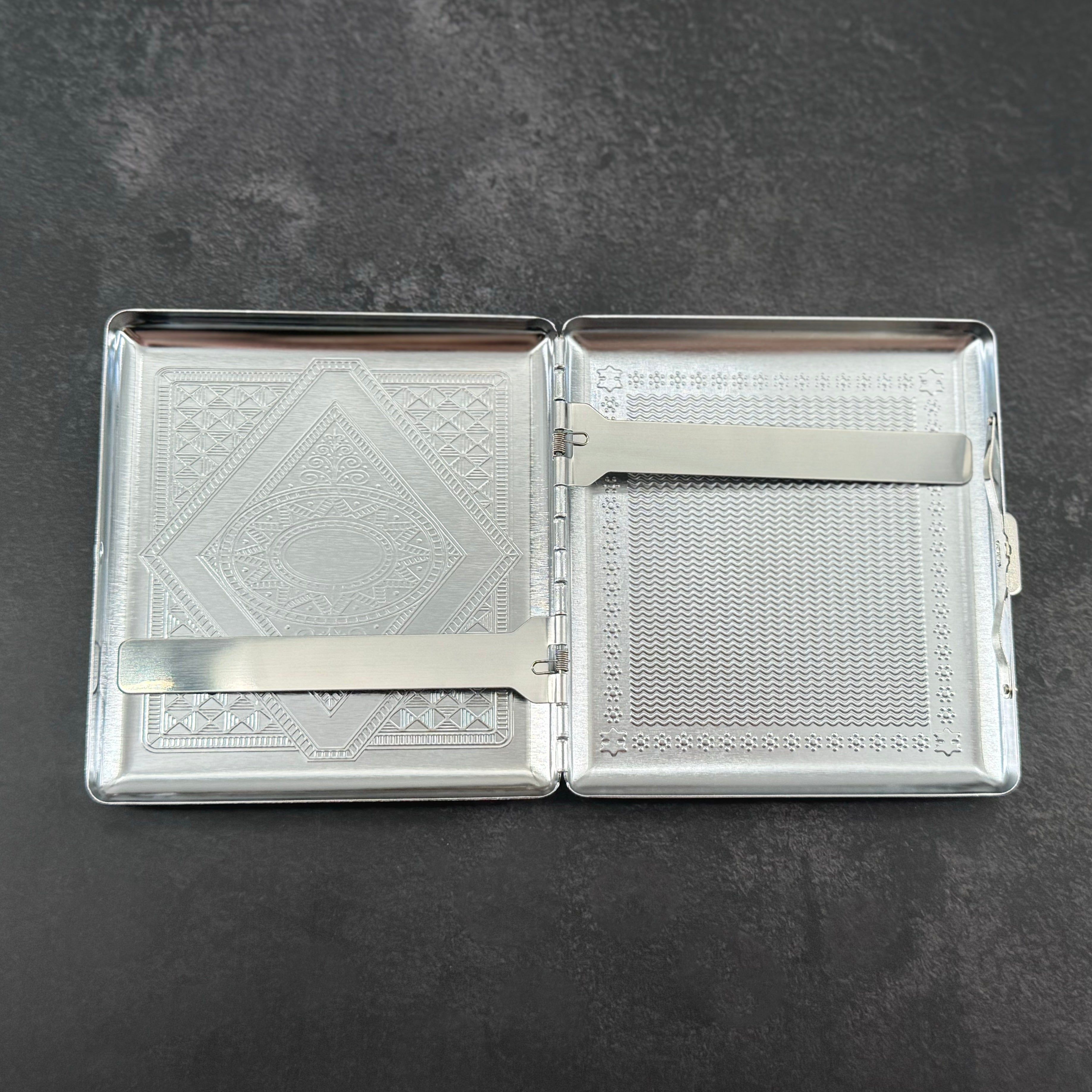 Open Death’s-head hawkmoth case showing the interior compartment and metal retaining arms