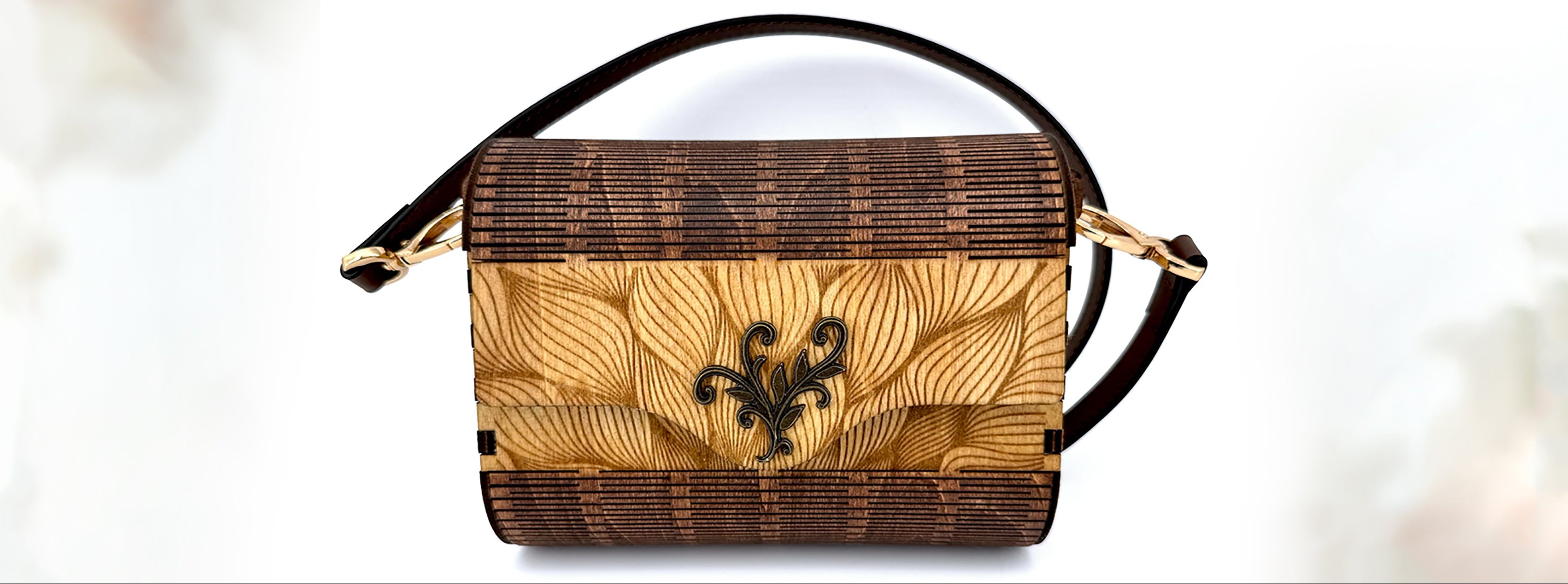 Handbag with floral pattern and fleur-de-lis design on a white background